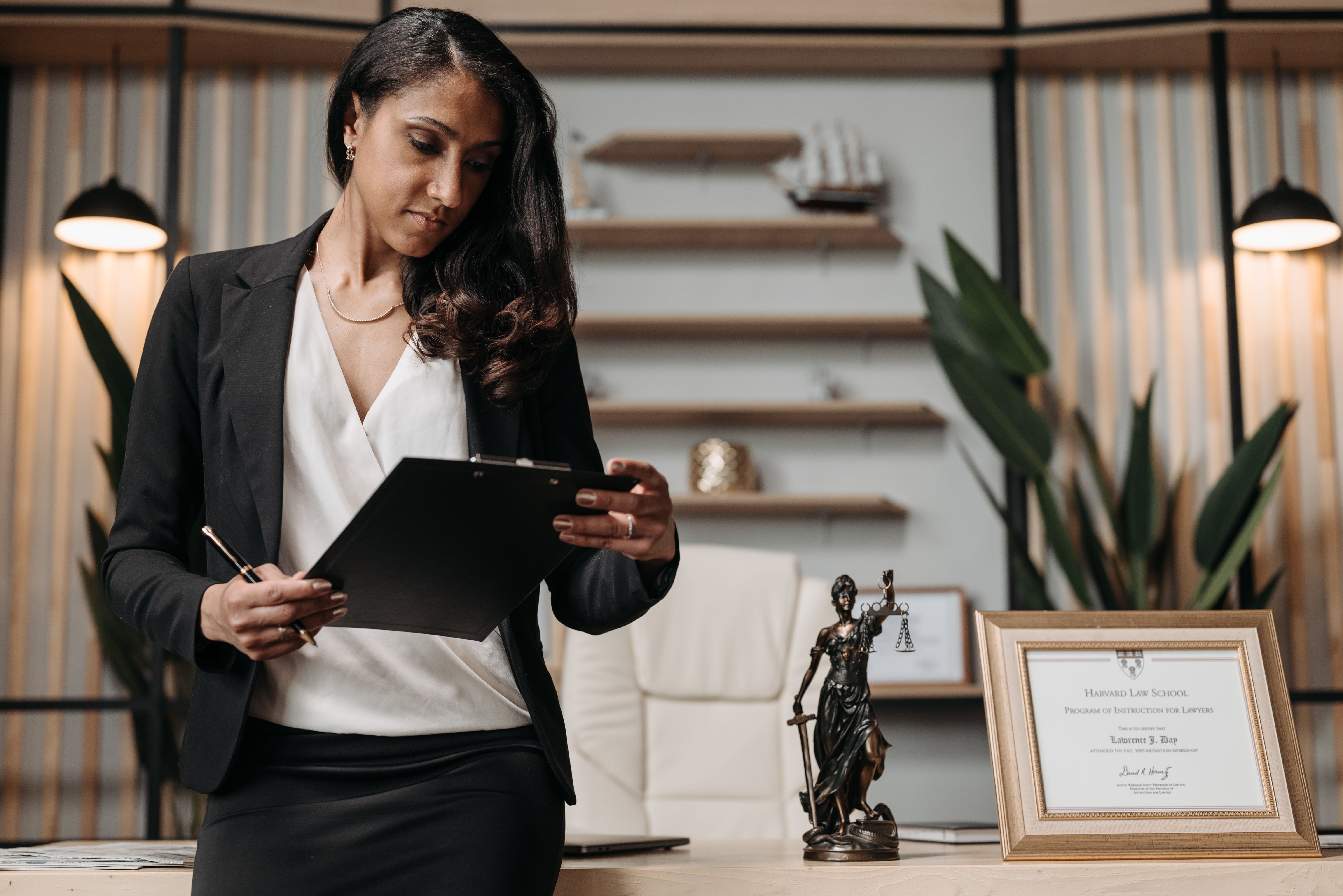Confident businesswoman reviewing paperwork in a modern law office