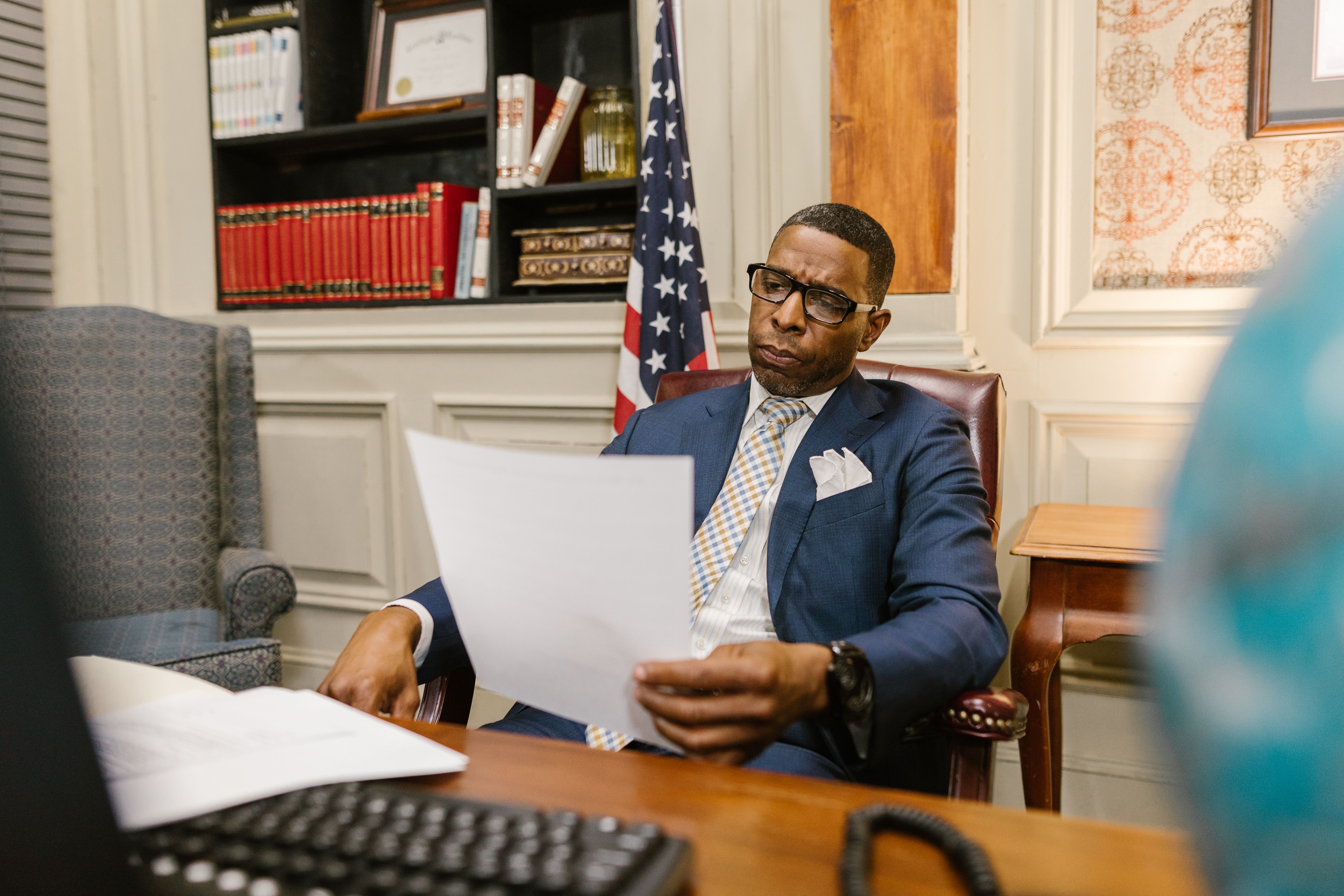 A lawyer attentively reviewing documents at his desk in a law office