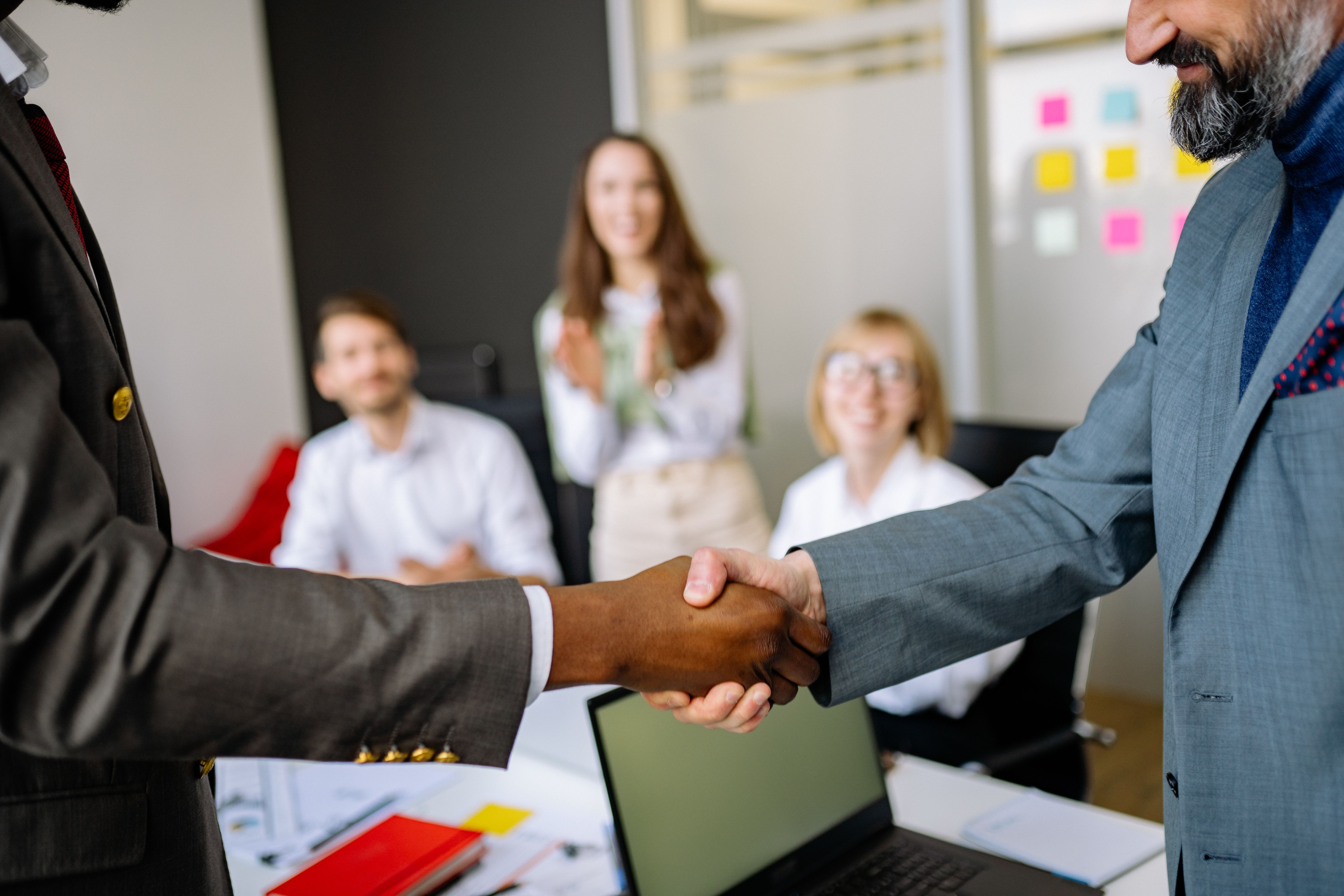 Business partners shaking hands to symbolize cooperation and regional stability
